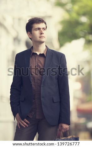 Man with shopping bags walking outdoors