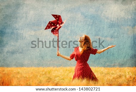 Redhead girl with toy wind turbine