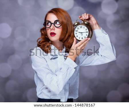 Redhead women with clock.