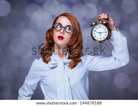 Redhead women with clock.