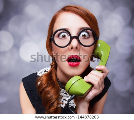 Redhead women with green telephone Redhead women with green telephone