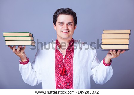 Man in embroidery shirt with books. Ukrainian national clothes.