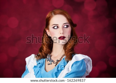 Portrait of a young redhead woman dressed as Alice in Wonderland, video game.