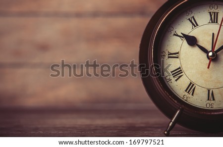 Retro Alarm Clock On A Table. Photo In Retro Color Image Style
