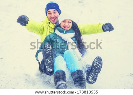 Teen couple in winter park.