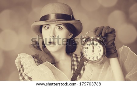Beautiful women with clock. Photo in retro style with bokeh at background.