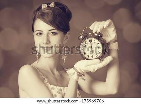 Beautiful women with clock. Photo in retro style with bokeh at background.