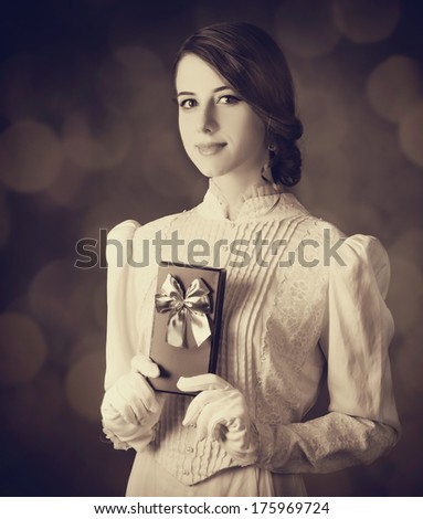 Beautiful women with gift. Photo in old color image style.
