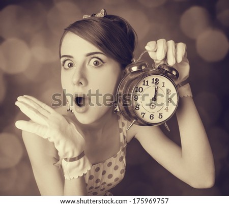 Beautifu women with clock. Photo in retro style with bokeh at background.