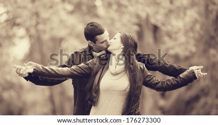 couple kissing outdoor in the park. Photo in old color image style.