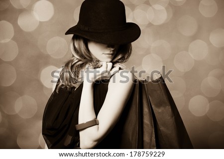 Style girl with shopping bags. Photo in old color image style.