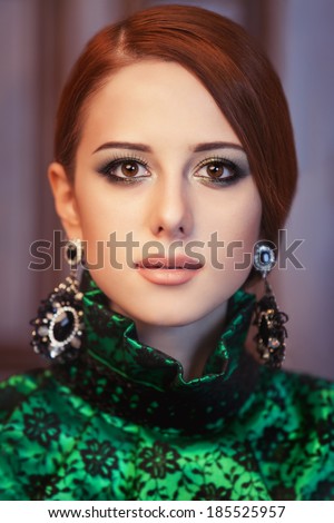 Portrait of a beautiful redhead women with earrings.