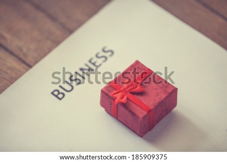 Gift and paper with business text