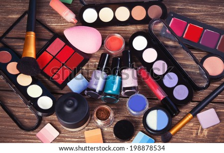Cosmetics on wooden table.