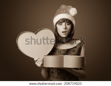 Portrait of a beautiful women with gift box. Photo in old sepia image style.