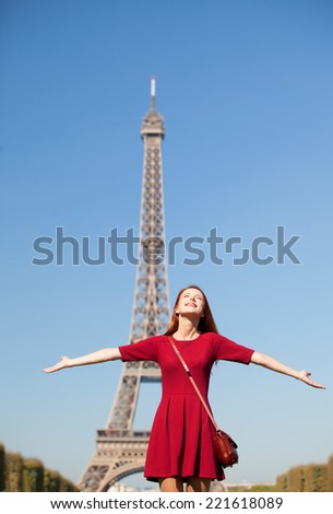 Beautiful girl in Paris with Eiffel tower on background.