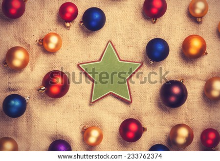 Star shape toy and color balls on jute background.