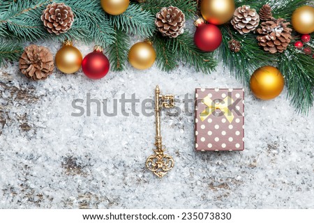 gift box with key and branch with toys.