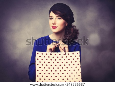 Portrait of beautiful women in blue dress with shopping bags and bokeh on background.