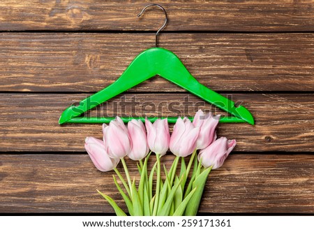 Tulips and hanger on a wooden background.