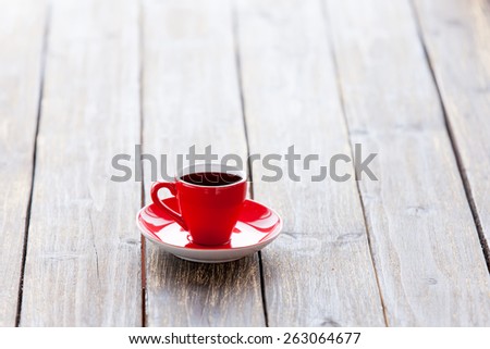 Cup of coffee on a wooden table. Side view.