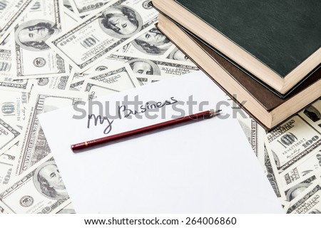 pencil and paper with My Business words and one hundred dollar bills