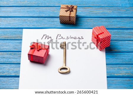 Key and paper with My Business words on blue background