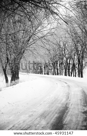 Road in snow through forest. Photo in retro style.