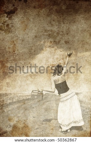 Girl dancing at wheat field road. Photo in old image style.