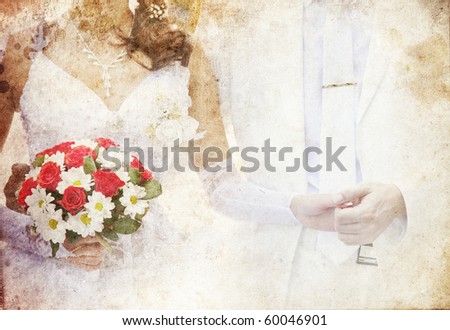 Bridegroom and bride holding beautiful red roses wedding flowers bouquet. Photo in old colour image style.
