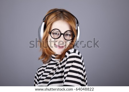 Funny girl with headphone and glasses. Studio shot.