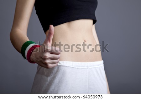 Beautiful and strong women\'s abs and hand OK. Studio shot.