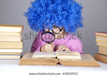 Funny blue-haired girl with loupe and books. Studio shot.