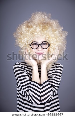 Portrait of funny girl in blonde wig. Studio shot.