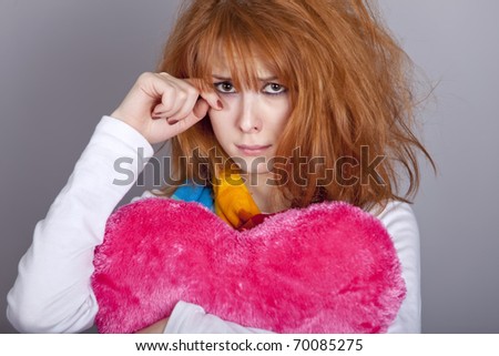 Sad girl with heart. St. Valentine Day