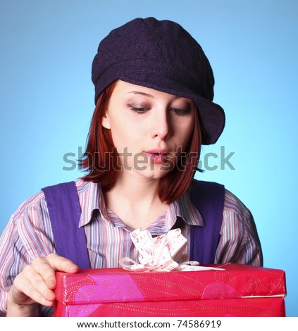 Beautiful girl looking at present in St. Valentine\'s Day