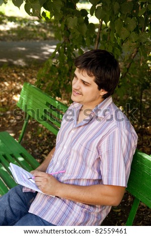 Men with glasses doing homework at the park.