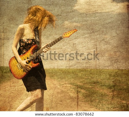Red-head girl with guitar. Photo in old image style.