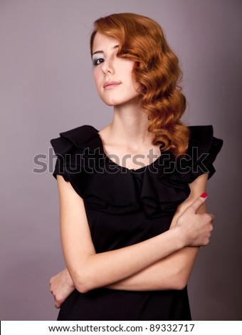 Portrait of beautiful young redhead woman with vintage hair style.