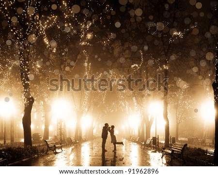 Couple walking at alley in night lights. Photo in vintage multicolor style.