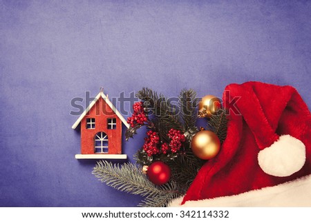 Toy house and christmas gifts on blue background