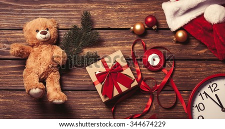Christmas gift-ready for packaging and teddy bear toy on a wooden background