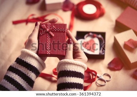 Woman preparing gift for wrapping for Valentine\'s Day