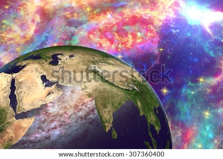 The Earth from space showing India and Arabian peninsula on globe on surrealistic background, galaxies are reflected in water, elements of this image furnished by NASA. Other orientations available