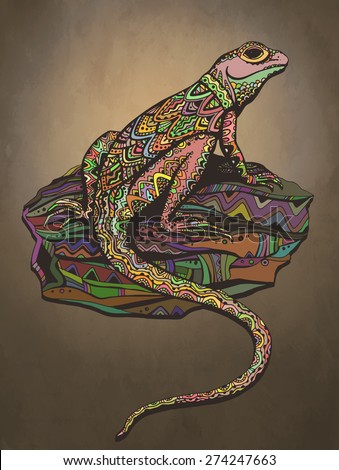 Ornate lizard with ethnic pattern. Rich colored reptile on a beautiful stone. Sunset background