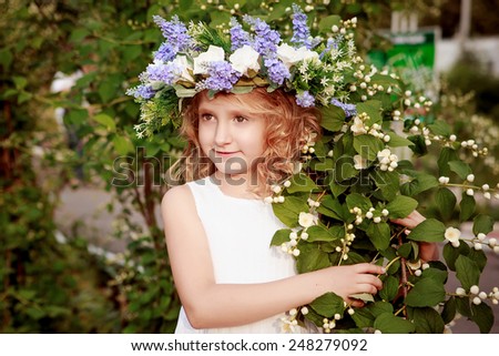 Portrait of the girl with a wreath on his head in the spring.