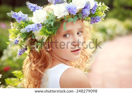 Portrait of the girl with a wreath on his head in the spring.