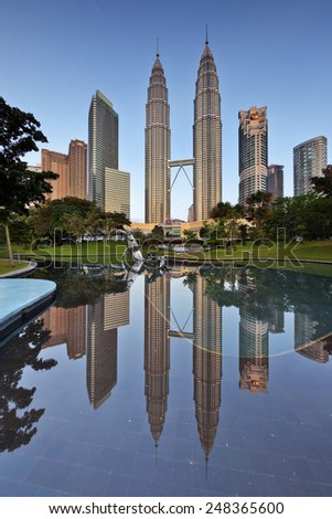 Kuala Lumpur, Malaysia  January 25 2015: The Petronas twin towers get reflected at still pool outside of Kuala Lumpur City Center (KLCC).