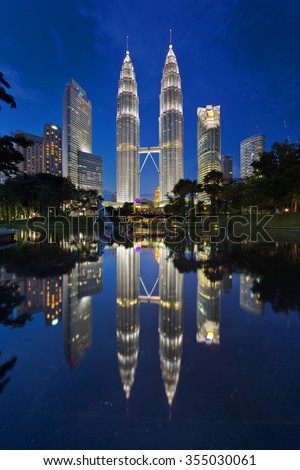 Kuala Lumpur, Malaysia January 25 2015: The Petronas twin towers get reflected at still pool outside of Kuala Lumpur City Center (KLCC).