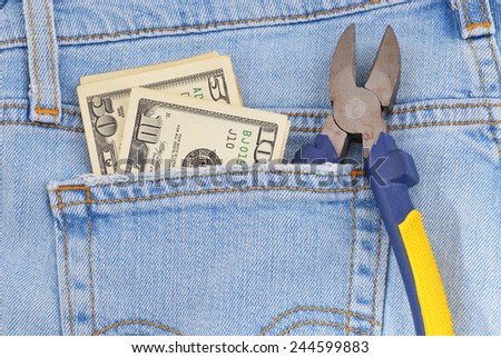 Money and tool in blue jeans pocket